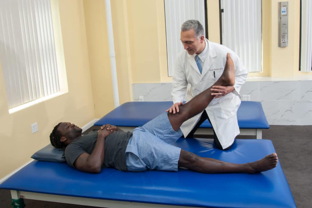 doctor of physical therapy the doctor gives physical therapy adjustment to nfl patient