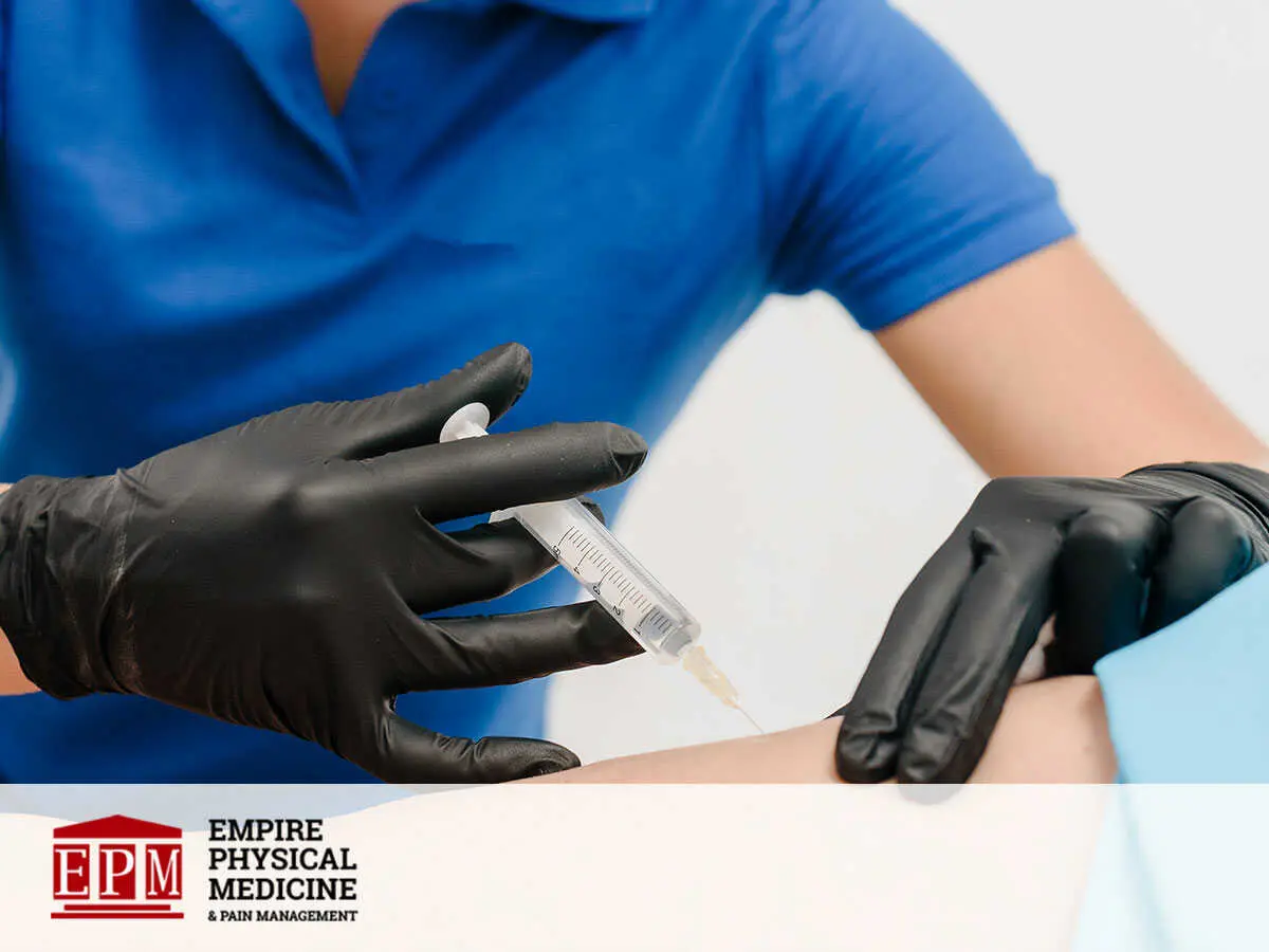 A physiotherapist giving an epidural steroid injection to a patient in Midtown Manhattan, NY